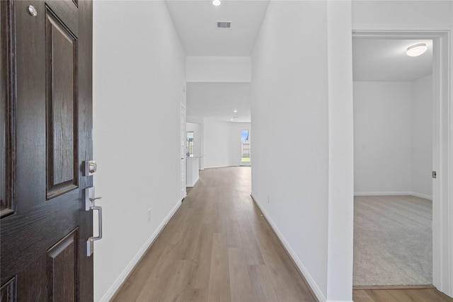 hallway with light hardwood / wood-style flooring