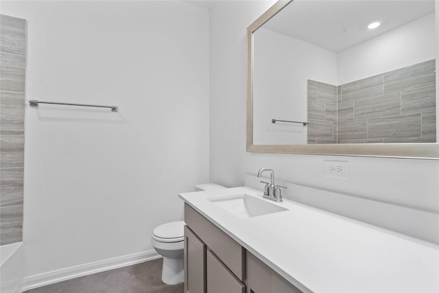 bathroom featuring vanity, toilet, and a tub to relax in