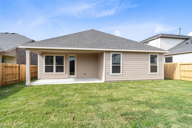 rear view of property with a lawn and a patio