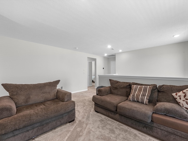 carpeted living room featuring a textured ceiling