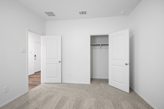 unfurnished bedroom featuring a closet and carpet floors