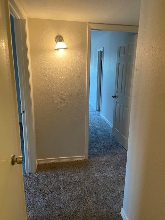 hallway with dark carpet