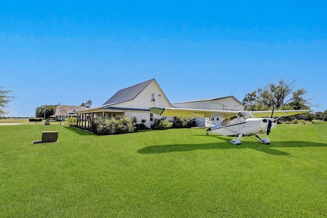 view of side of home with a yard