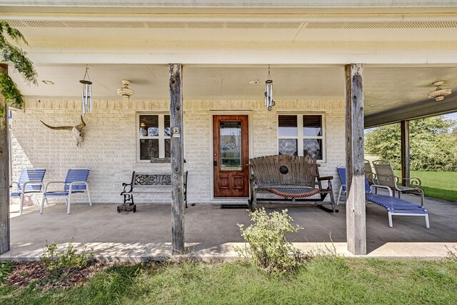 view of exterior entry with a porch