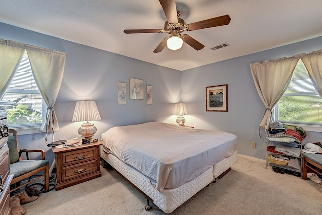 bedroom with ceiling fan and light carpet