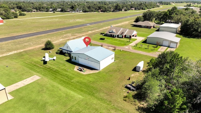 birds eye view of property with a rural view