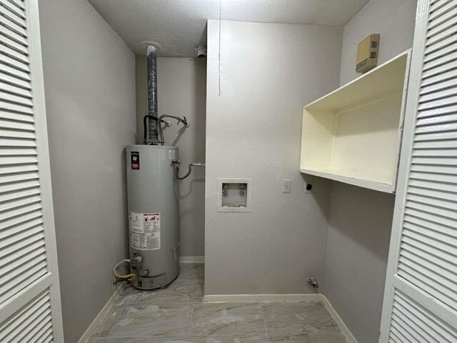 11807 S Youngwood Ln, Houston, TX 77043 - washroom with electric dryer hookup, water heater, washer hookup, marble finish floors, and a textured ceiling