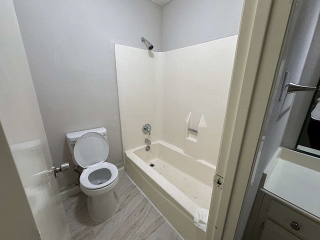 full bathroom featuring vanity, toilet, hardwood / wood-style flooring, and tub / shower combination