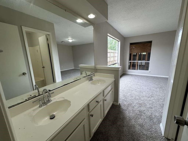 11807 S Youngwood Ln, Houston, TX 77043 - full bathroom with a textured ceiling, baseboards, double vanity, a shower, and a bathtub
