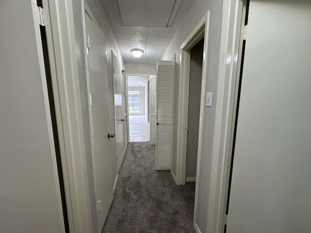 11807 S Youngwood Ln, Houston, TX 77043 - corridor with carpet, attic access, a textured ceiling, and baseboards