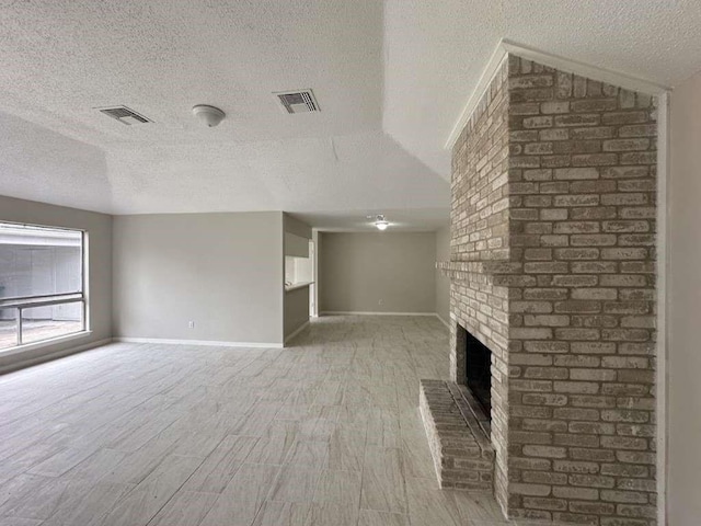 11807 S Youngwood Ln, Houston, TX 77043 - unfurnished living room with a textured ceiling, a fireplace, light wood-type flooring, and baseboards