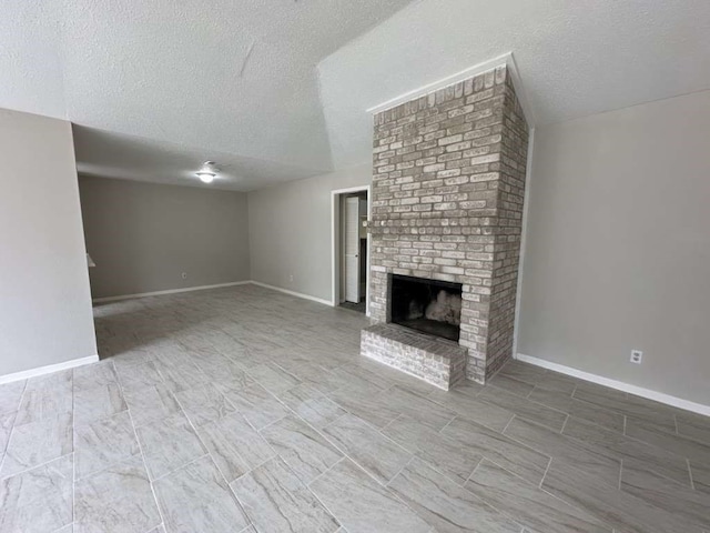 unfurnished living room with a textured ceiling, vaulted ceiling, and a fireplace