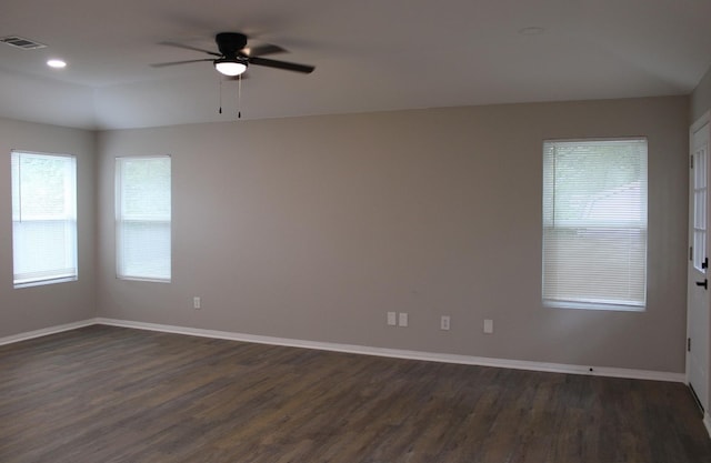 empty room featuring dark wood-type flooring and ceiling fan