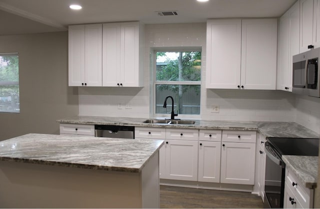 kitchen with white cabinetry, stainless steel appliances, sink, and dark hardwood / wood-style floors