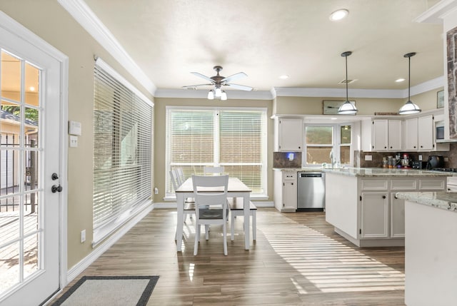 kitchen with light hardwood / wood-style flooring, white cabinetry, ceiling fan, pendant lighting, and stainless steel dishwasher