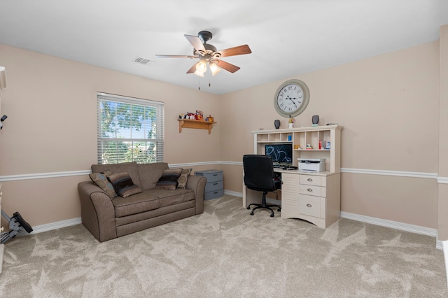 office space featuring light carpet and ceiling fan