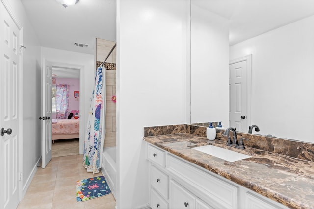 bathroom with vanity, tile patterned floors, and shower / bath combo with shower curtain