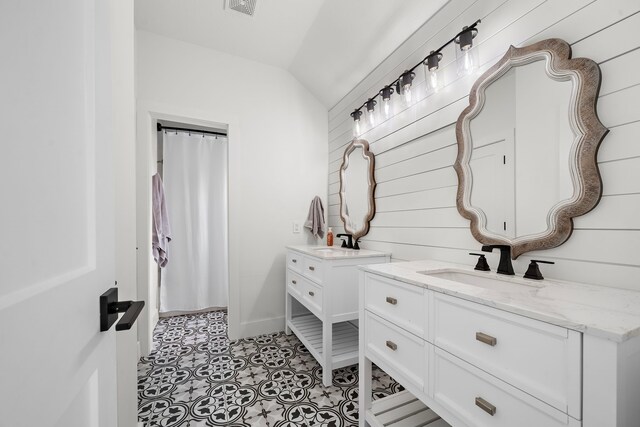 bathroom with vanity and vaulted ceiling