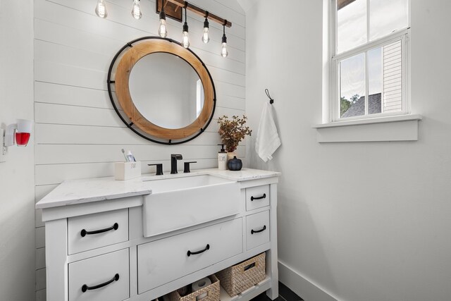 bathroom with wooden walls and vanity