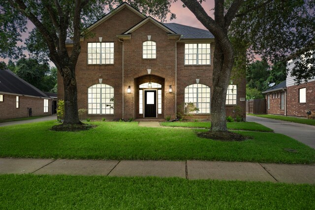 view of front of property featuring a yard and french doors