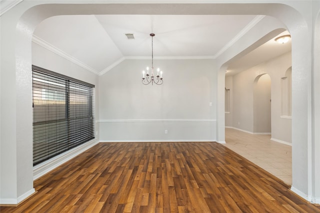 unfurnished room with wood-type flooring, vaulted ceiling, a chandelier, and crown molding