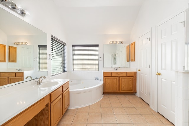 bathroom featuring vanity, tile patterned floors, and a washtub