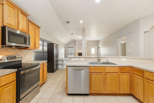 kitchen featuring tasteful backsplash, sink, light tile patterned floors, and stainless steel appliances