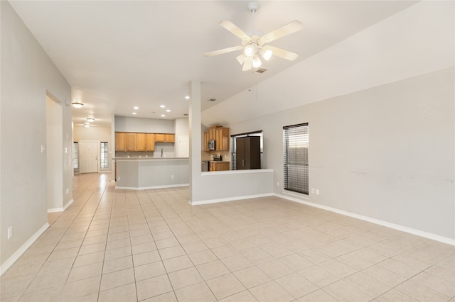 unfurnished living room with lofted ceiling, ceiling fan, and light tile patterned floors