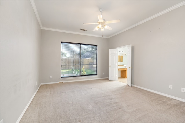 carpeted spare room with crown molding and ceiling fan