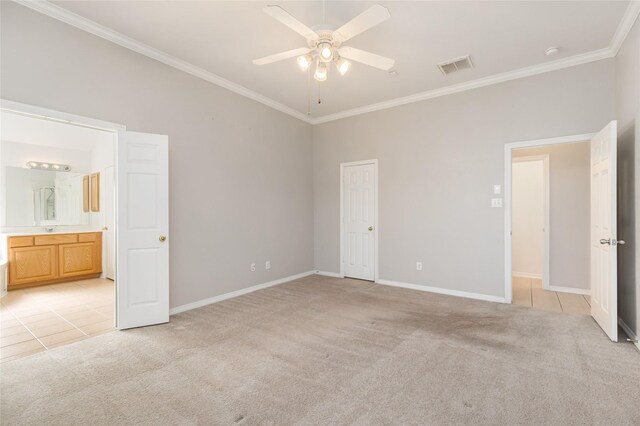 unfurnished bedroom with light carpet, ensuite bath, ornamental molding, and ceiling fan