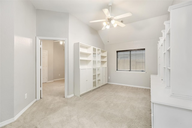 spare room featuring lofted ceiling, light carpet, and ceiling fan