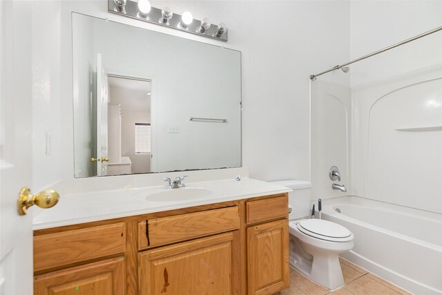 full bathroom with vanity, tile patterned floors, washtub / shower combination, and toilet