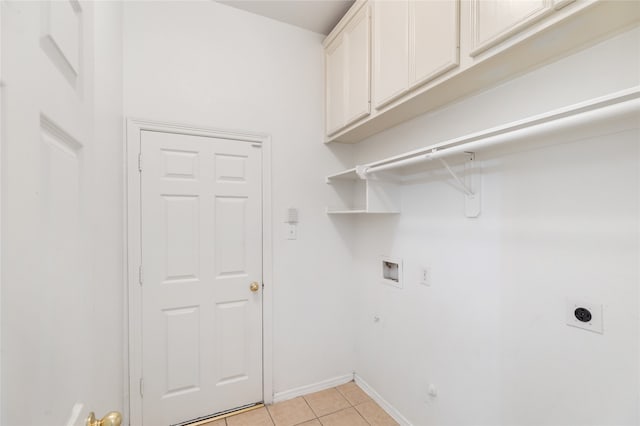 laundry room with hookup for a washing machine, light tile patterned floors, hookup for a gas dryer, hookup for an electric dryer, and cabinets