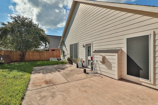 view of property exterior with a patio area and a yard