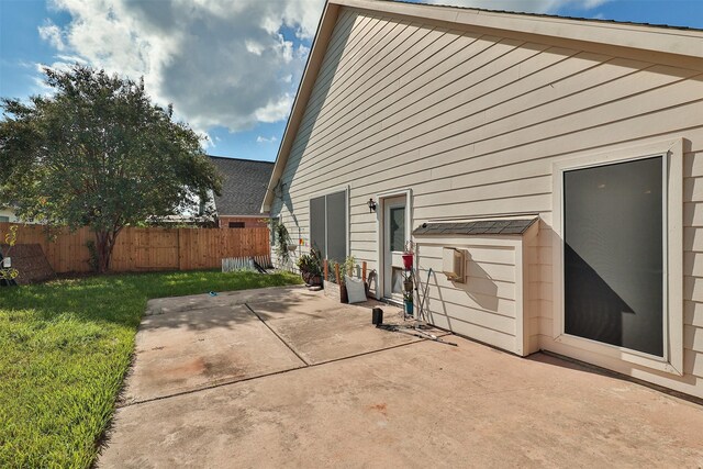 back of property featuring a patio and a yard