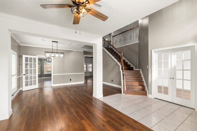 interior space featuring light hardwood / wood-style floors, ceiling fan, french doors, and ornamental molding