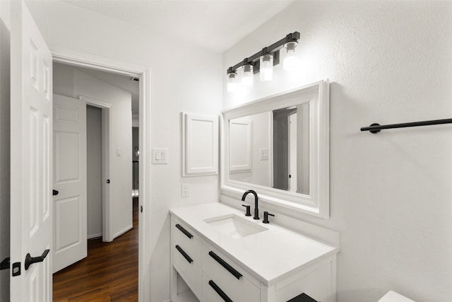 bathroom with hardwood / wood-style flooring and vanity