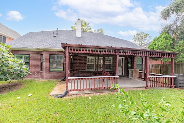 rear view of house featuring a lawn and cooling unit