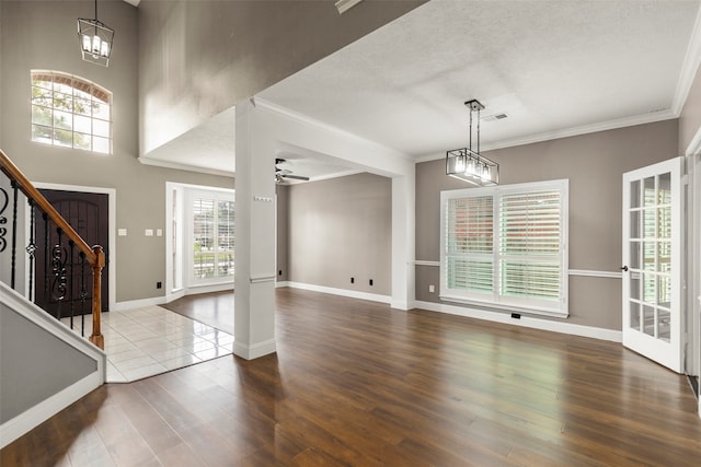 foyer featuring a wealth of natural light, hardwood / wood-style flooring, and ceiling fan with notable chandelier