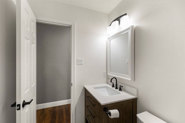 bathroom featuring hardwood / wood-style floors, vanity, and toilet