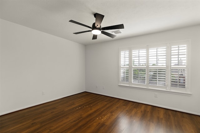 spare room with ceiling fan, dark hardwood / wood-style floors, and a textured ceiling