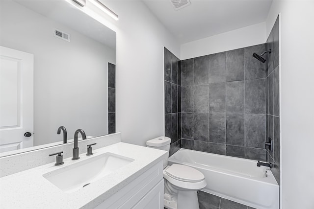 full bathroom with vanity, tile patterned flooring, tiled shower / bath, and toilet