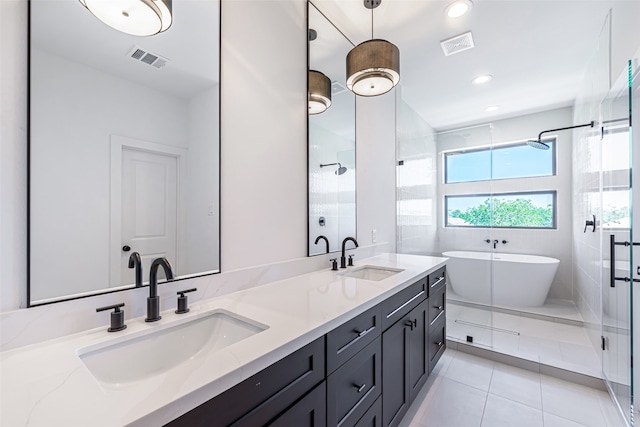 bathroom featuring independent shower and bath, vanity, and tile patterned floors