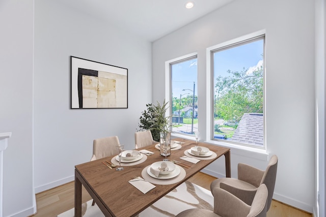 dining space with light hardwood / wood-style flooring and a wealth of natural light