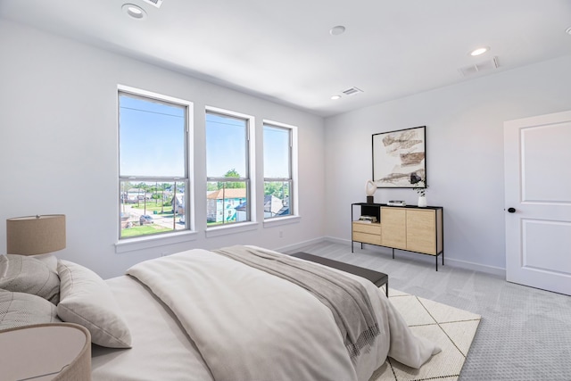 bedroom featuring light colored carpet