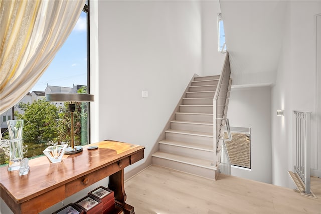 stairway featuring hardwood / wood-style floors and plenty of natural light