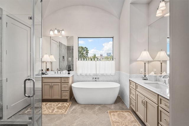 bathroom with vanity, vaulted ceiling, and plus walk in shower