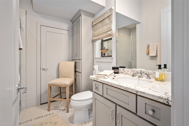 bathroom with vanity, toilet, an enclosed shower, and tile patterned floors