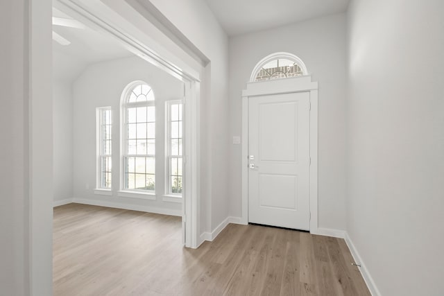 entryway with lofted ceiling, light hardwood / wood-style floors, and ceiling fan