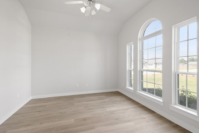 unfurnished room with lofted ceiling, light hardwood / wood-style floors, and ceiling fan